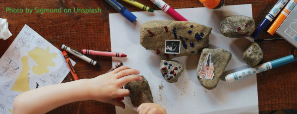 child with rocks